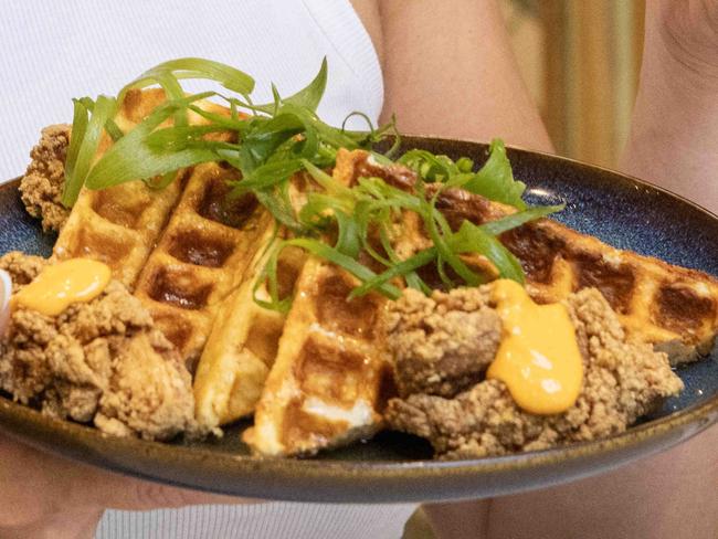 31st October, 2023: Customer Tayla McKay samples the fried chicken with waffles and maple syrup at Hello Neighbour in Hyde Park. Picture by Kelly barnes