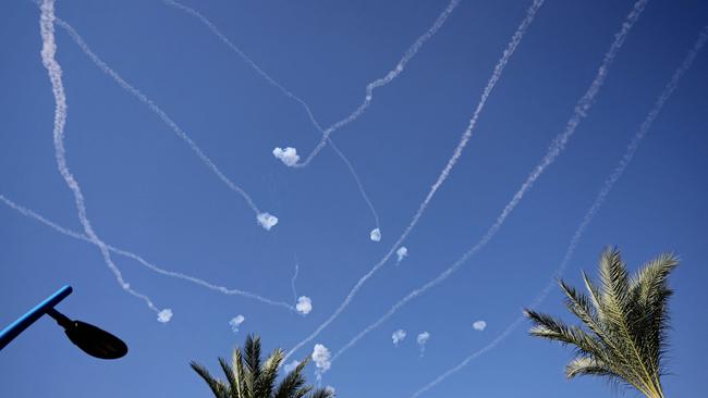 A picture taken from the Israeli city of Sderot shows rockets fired from the Gaza Strip intercepted by Israel's Iron Dome defence missile system.