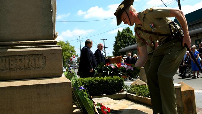 Defence Forces representative laying a wreath.