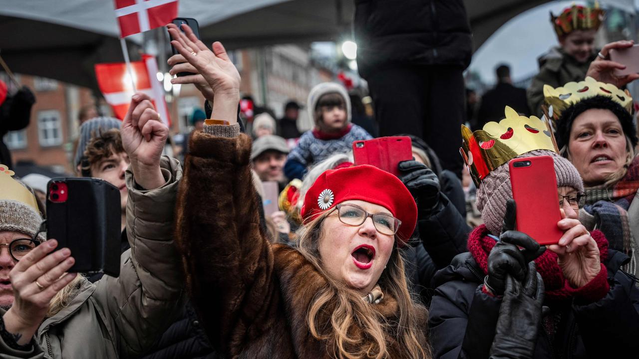 People celebrate the declaration on the accession to the throne of King Frederik X of Denmark (unseen) and Queen Mary of Denmark (unseen) at the Christiansborg Palace Square in Copenhagen, Denmark on January 14, 2024. Denmark turned a page in its history on January 14 as Queen Margrethe II abdicated the throne and her son became King Frederik X, with more than 100,000 Danes turning out for the unprecedented event. (Photo by Emil Nicolai Helms / Ritzau Scanpix / AFP) / Denmark OUT