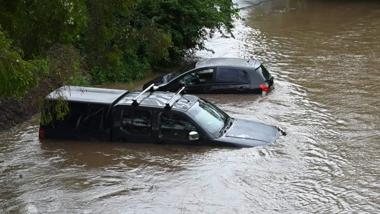 Cars washed away in floodwaters at Nambour on the Sunshine Coast on Wednesday. Picture: Jean Dunning