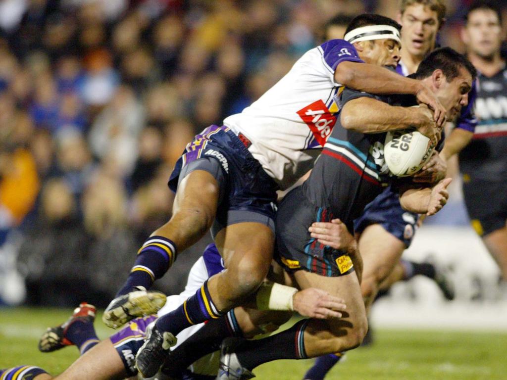 Scott Sattler tries to break a Steve Kearney tackle. Picture: AAP