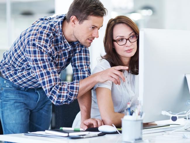 Shot of a young office worker getting some assistance from her manager