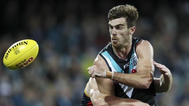 Port Adelaide’s Scott Lycett handballs under pressure. Picture: Sarah Reed