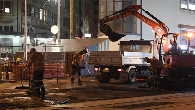 Workers lay asphalt on Chalmers St next to Central last week. Picture: Gordon McComiskie