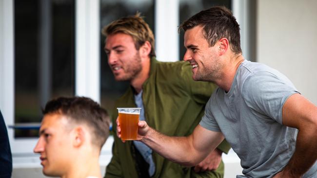 Crouch enjoying some end of season drinks with teammates Tom Doedee (left) and Daniel Talia. Picture: Adelaide Football Club