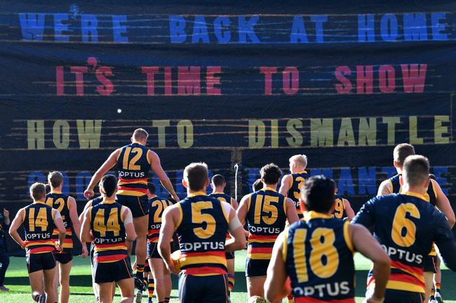 Crows players run onto the Adelaide Oval for the Round 7 match against the Fremantle Dockers on Sunday. Picture: David Mariuz/AAP