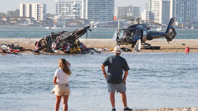 Two EC130 choppers collided into one another on Monday afternoon, with one crashing upside down on a sandbank while the other damaged aircraft landed nearby safely. Picture: Glenn Hampson