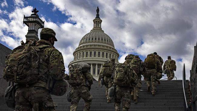 National Guard soldier head to the east front of the US Capitol ahead of President-elect Joe Biden’s inauguration. Picture: AFP