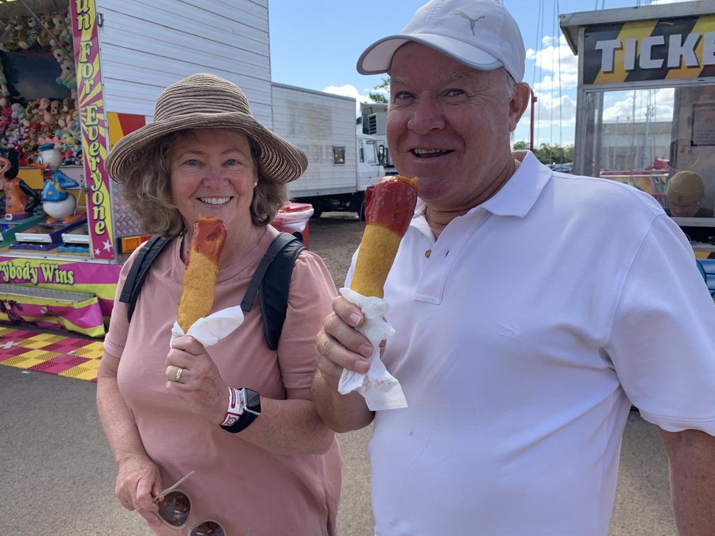 Margaret and Paul Stanton from Canberra enjoy a fresh dagwood dog at the Fraser Coast Ag Show for 2021.