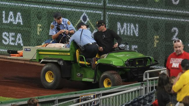 The fan is carted off the field at PNC Park. (AP Photo/Gene J. Puskar)