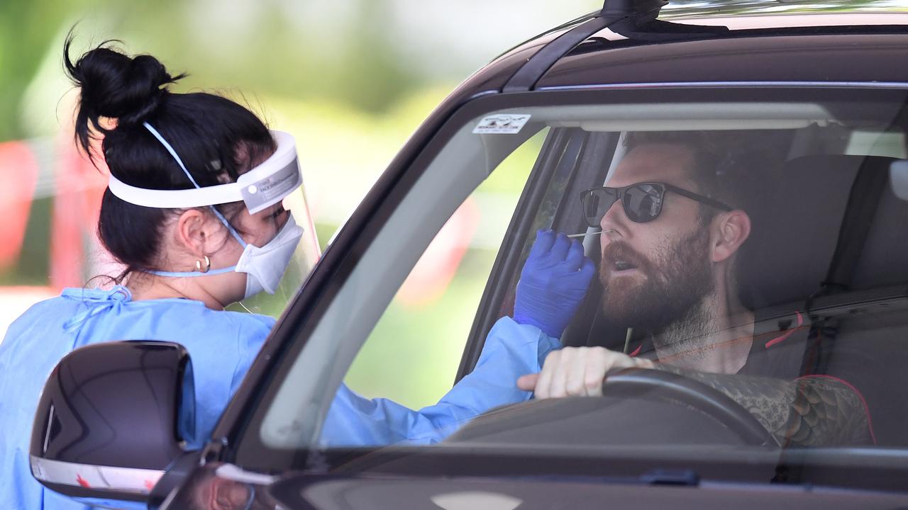 A health worker swabs a man at a Covid-19 testing clinic in Murarrie as Queensland wrangles with the potential spread of the Omicron variant in the community. Picture: NCA NewsWire / Dan Peled