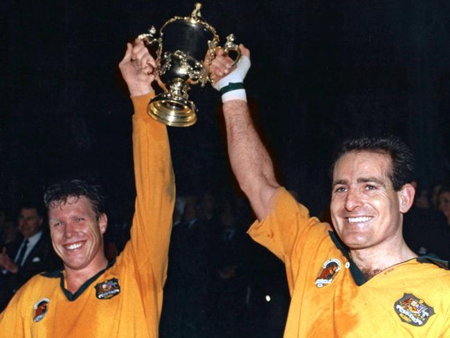 Wallaby captain Nick Farr-Jones (left) and winger David Campese hoist the World Cup in 1991. Picture: AFP