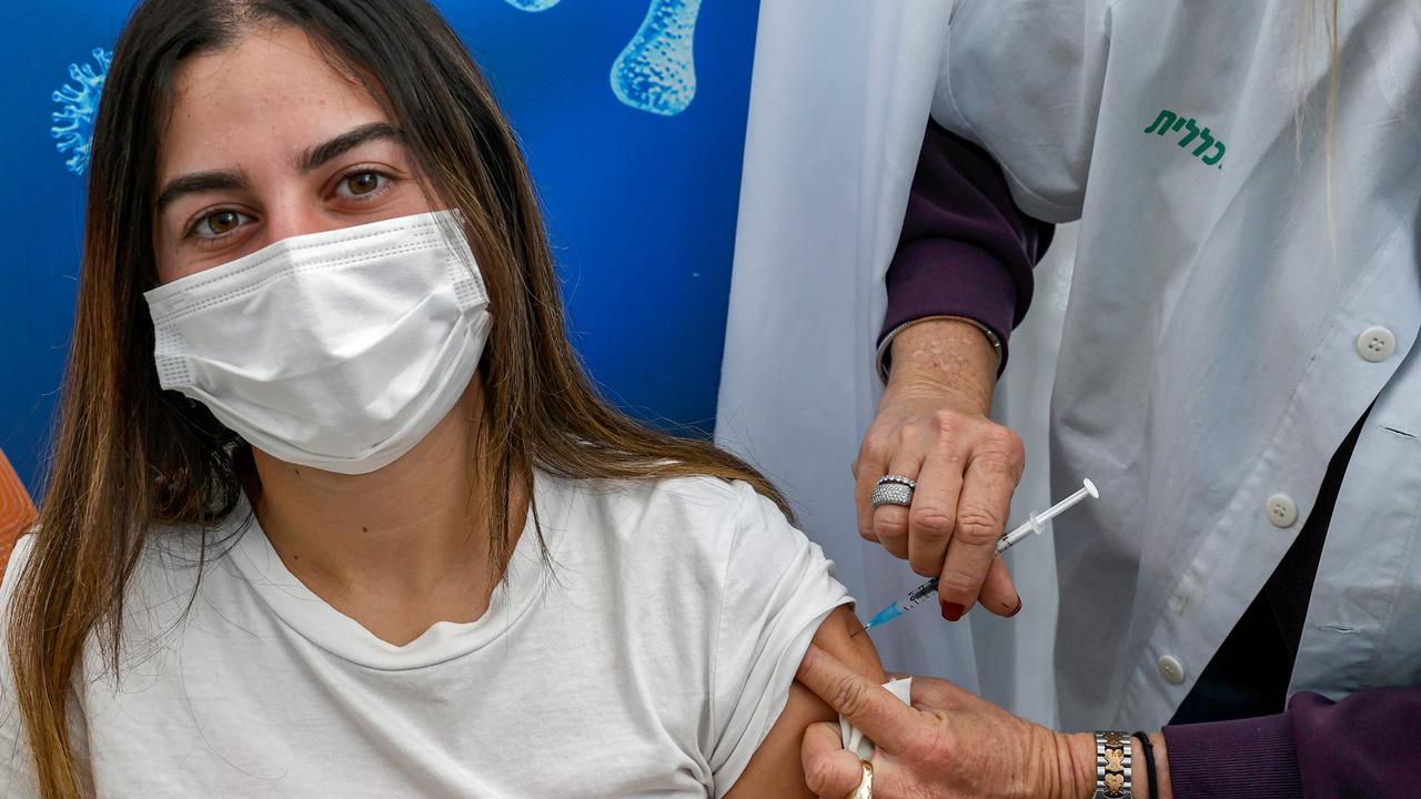 A young woman gets the COVID vaccine in Israel. Picture: Jack Guez/AFP