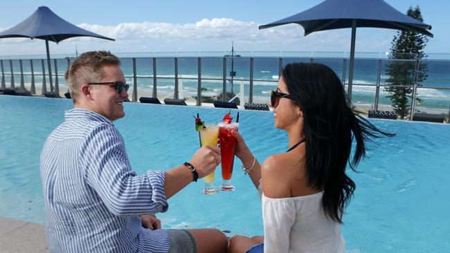 Clare Rigby, 21, and Luke Roberts 20, on the pool deck at Soul Mantra Surfers Paradise. Pic Tim Marsden