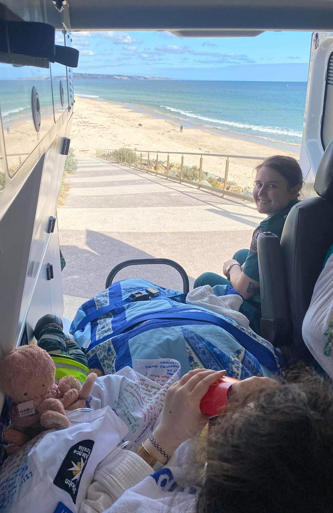 Lily Thai and Danika Pederzolli in the back of an ambulance, enjoying McDonald's at the beach. Picture: Danika Pederzolli/Facebook