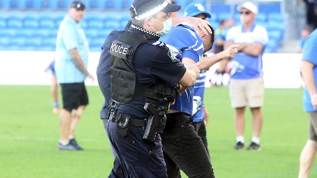 A male was arrested after throughing punches at the referee. Picture: Richard Gosling