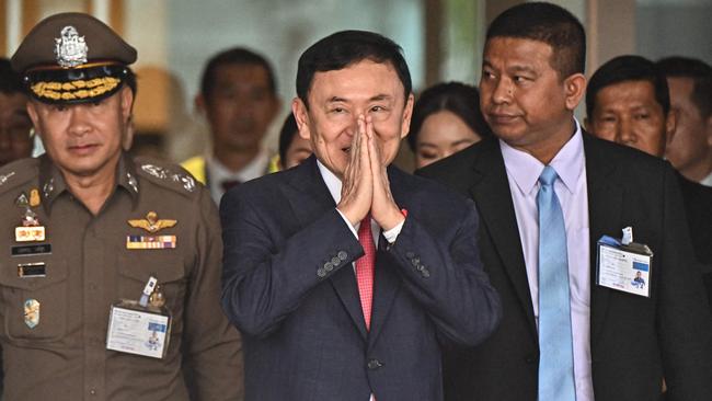 Former Thai prime minister Thaksin Shinawatra greets his supporters after landing in Bangkok on Tuesday. Picture: AFP