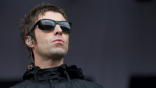 (FILES) This file photo taken on June 28, 2013 shows British singer Liam Gallagher gesture to the crowed while performing with his band Beady Eye on third day of the Glastonbury Festival of Contemporary Performing Arts near Glastonbury, southwest England. Oasis frontman Liam Gallagher on May 26, 2017 announced his solo debut with a concert in his native Manchester to support families affected by the deadly suicide attack at the city's arena. / AFP PHOTO / ANDREW COWIE