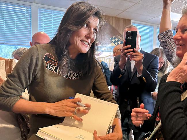 Former US ambassador to the United Nations and Republican presidential hopeful Nikki Haley (L) chats with a supporter following a town hall event at an American Legion center in Laconia, New Hampshire on April 28, 2023. (Photo by Michael Mathes / AFP)