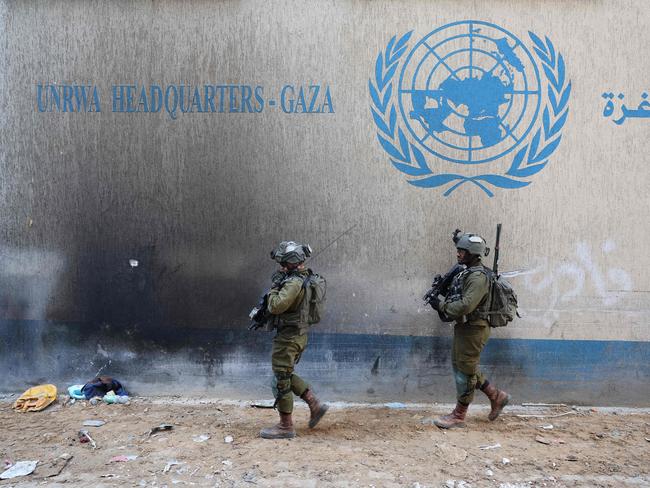 --PHOTO TAKEN DURING A CONTROLLED TOUR AND SUBSEQUENTLY EDITED UNDER THE SUPERVISION OF THE ISRAELI MILITARY-- This picture taken during a media tour organised by the Israeli army on February 8, 2024, shows Israeli soldiers inside a compound of the United Nations Relief and Works Agency for Palestine Refugees (UNRWA) in the Gaza Strip, amid ongoing fighting between Israel and the Palestinian militant group Hamas. (Photo by JACK GUEZ / AFP)