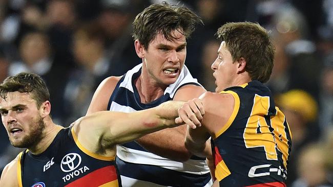 Tom Hawkins has a push and shove with Matt Crouch. Picture: AAP