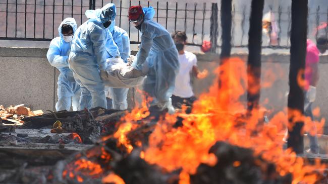 Relatives carry the body of a COVID-19 victim for cremation, at Seema Puri crematorium, in New Delhi, India. Picture: Getty Images