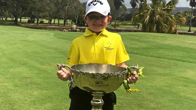 Rockhampton's Eli Parsons proudly displays the US Kids Golf Trans-Tasman Cup, which he and his Australian teammates won on the Gold Coast. Picture: CONTRIBUTED