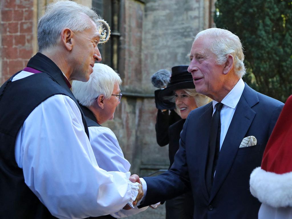 King Charles III and Britain's Camilla, Queen Consort are greeted by Dean of Llandaff Cathedral Michael Komor. Picture: AFP.