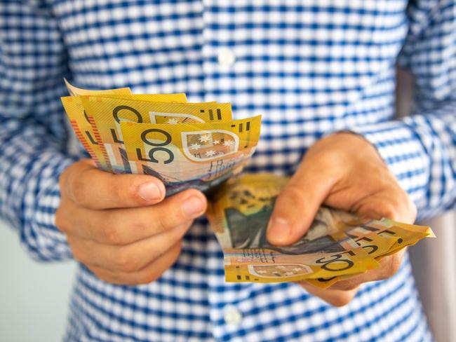 Man handling fifty dollar notes finance. Money and bills economy  Picture: istock