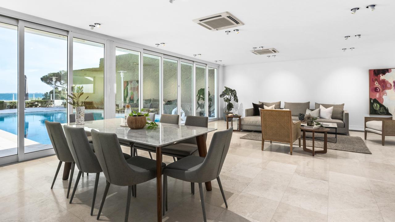 The dining space looks out on the pool.