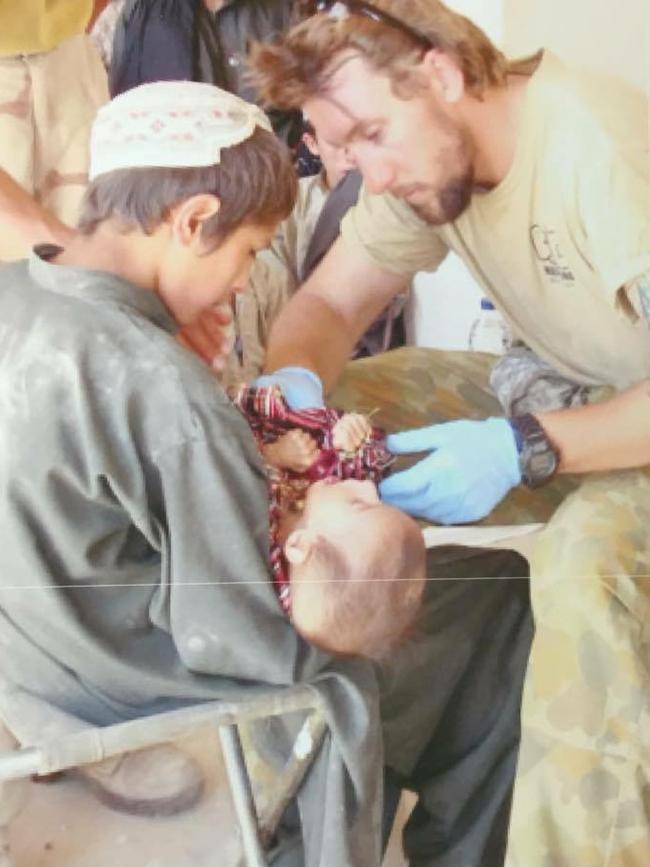 Terry Ledgard treats a local in Afghanistan. Picture Supplied