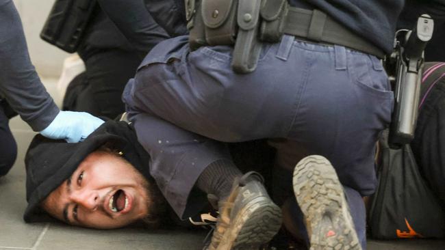 A construction worker being arrested near the CFMEU office in Melbourne on Tuesday night. Picture: Wayne Taylor