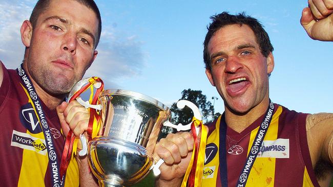 Monbulk captain Vin Dunstan and coach Chris Hughson celebrate a premiership win. Picture: Andy Drewitt