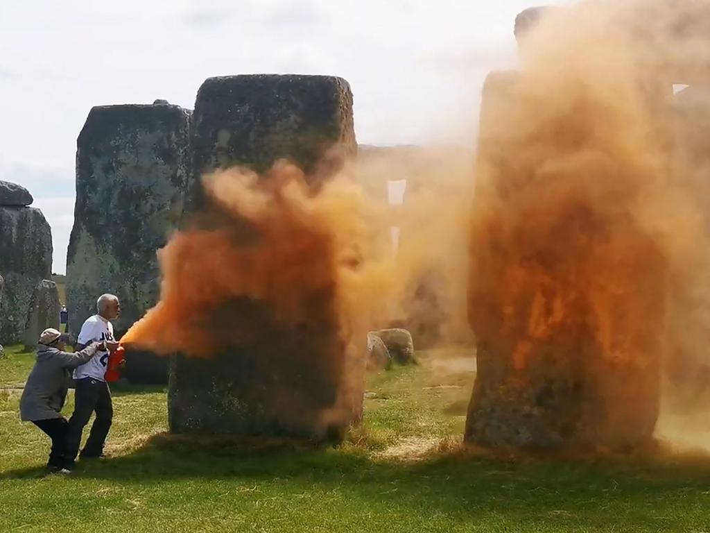 TOPSHOT - An image grab from a video released by the Just Stop Oil climate campaign group shows activists spraying an orange substance at Stonehenge in Wiltshire, southwest England, on June 19, 2024. UK police said officers had arrested two people after environmental activists sprayed an orange substance on Stonehenge, the renowned prehistoric UNESCO World Heritage Site in southwest England. (Photo by Handout / Just Stop Oil / AFP) / RESTRICTED TO EDITORIAL USE - MANDATORY CREDIT "AFP PHOTO / JUST STOP OIL" - NO MARKETING NO ADVERTISING CAMPAIGNS - DISTRIBUTED AS A SERVICE TO CLIENTS