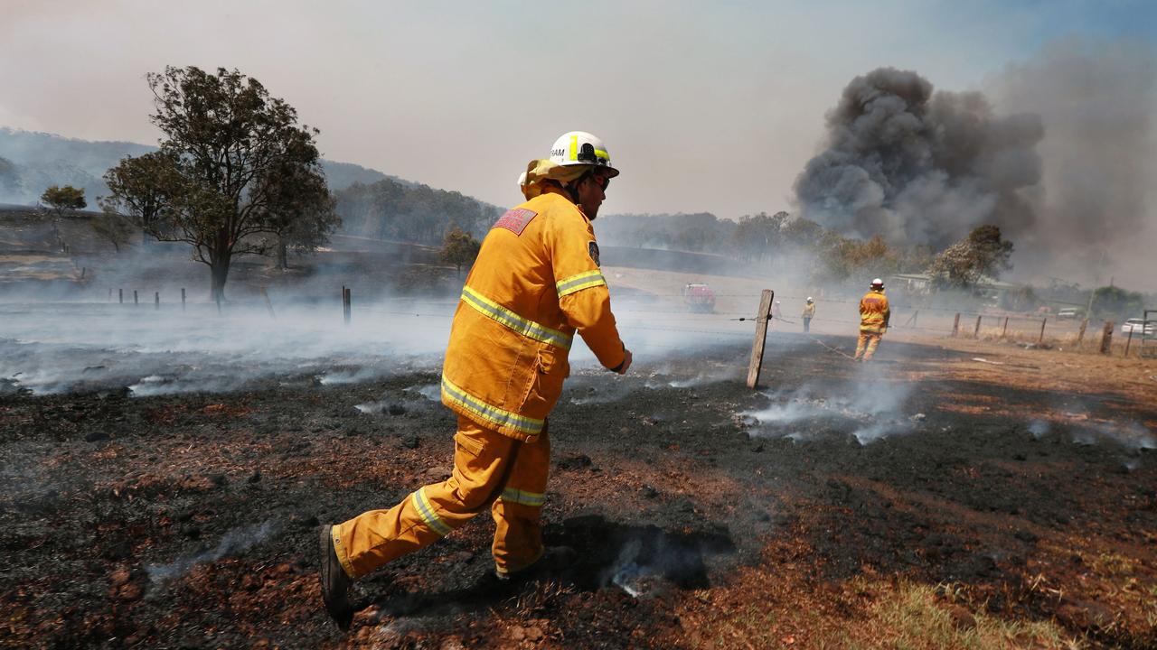 Helicopter water bombers drop badly needed water to protect property. Picture: Gary Ramage