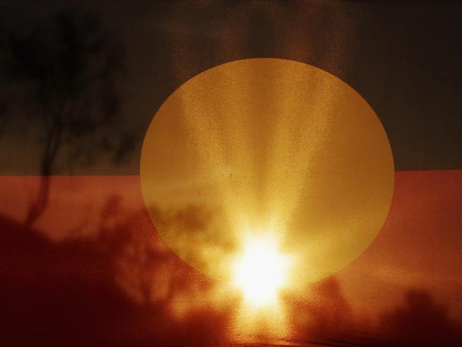 ALICE SPRINGS, AUSTRALIA - FEBRUARY 07:  The Aboriginal Flag flies during a photo shoot on February 7, 2017 in Alice Springs, Australia.  (Photo by Darrian Traynor - CA/Cricket Australia via Getty Images/Getty Images)