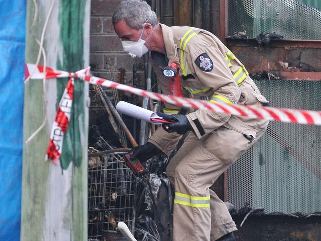 An expert investigates the fire. Picture: Hamish Blair