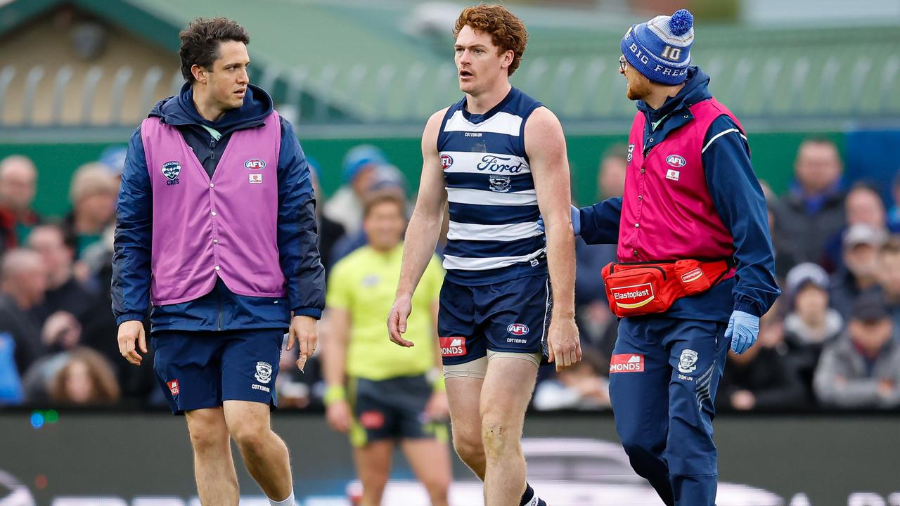 HOBART, AUSTRALIA - JULY 27: Gary Rohan of the Cats is assisted off the ground by medical staff after a head collision during the 2024 AFL Round 20 match between the North Melbourne Kangaroos and the Geelong Cats at Blundstone Arena on July 27, 2024 in Hobart, Australia. (Photo by Dylan Burns/AFL Photos via Getty Images)