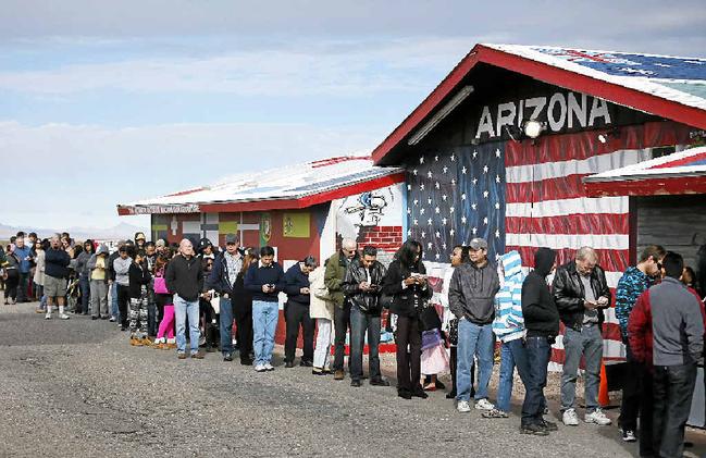 DREAM CHASERS: Thousands wait in line to buy Powerball lottery tickets in America. Picture: John Locher