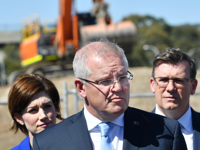 Prime Minister Scott Morrison is seen with Minister for Population, Cities and Urban Infrastructure Alan Tudge and Liberal member for Boothby Nicolle Flint during a regional infrastructure announcement at the Flinders Link works site in Adelaide. Picture: AAP IMAGE/DAVID MARIUZ