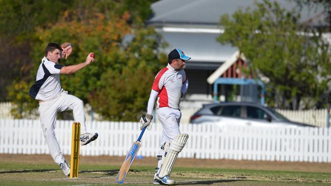 Mitch Bourke bowls for Maryvale and Kev Poole backs up for Colts in the Condamine Cup A-grade cricket grand final.