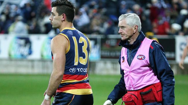 Adelaide's doctor checks up on Taylor Walker at Kardinia Park. Picture: George Salpigtidis
