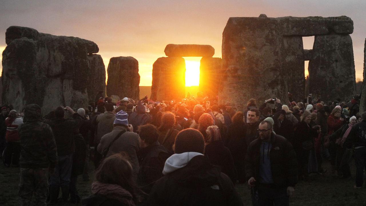People watch the sunrise at the northern Winter Solstice celebration at Stonehenge in Wiltshire, England, 22/12/2011. The omens are good that 2012 will be an excellent year, a druid said today, after the sun shone on Stonehenge during a dawn ceremony to mark the winter solstice. One of the most famous sites in the world, Stonehenge is composed of a circular setting of large standing stones set within earthworks, believed to be thousands of years old.