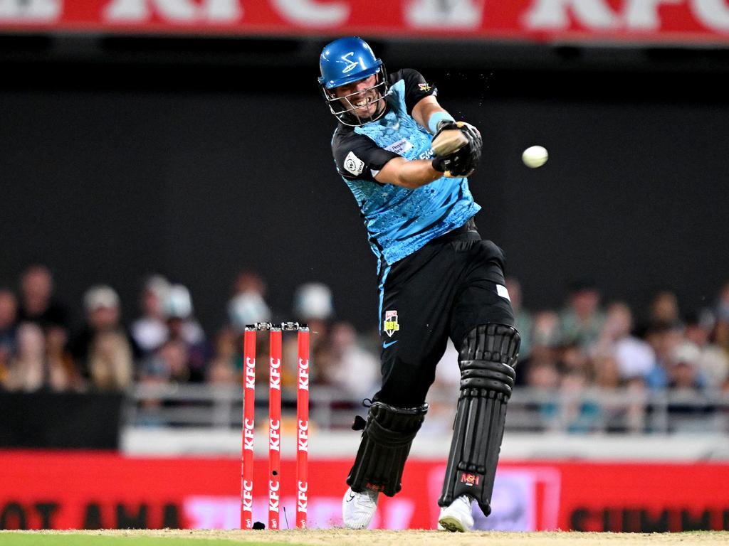 Jamie Overton smashes the ball during his unbeaten innings of 45 for the Adelaide Strikers against Brisbane Heat. Picture: Bradley Kanaris/Getty Images