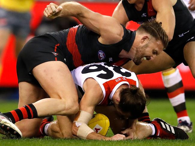 MELBOURNE, AUSTRALIA - AUGUST 10: Cale Hooker of the Bombers swings a punch at Daniel McKenzie of the Saints during the 2018 AFL round 21 match between the Essendon Bombers and the St Kilda Saints at Etihad Stadium on August 10, 2018 in Melbourne, Australia. (Photo by Adam Trafford/AFL Media/Getty Images)