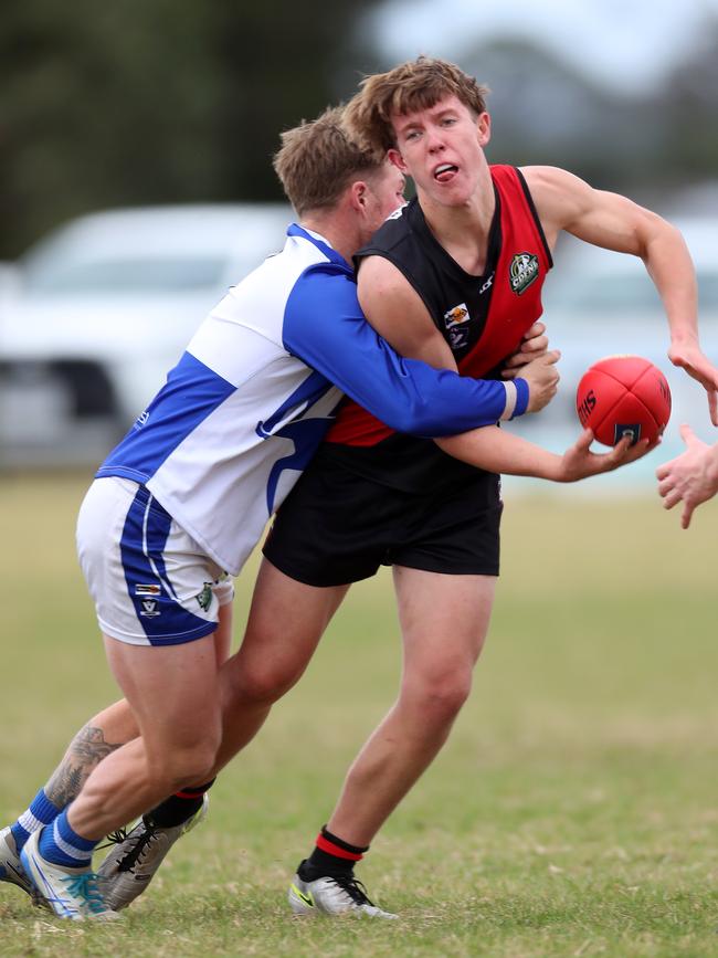 Irrewarra-Beac’s Hudson Dewar is tackled by South Colac rival Joshua Woods.