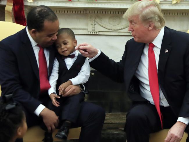 President Donald Trump jokes with Aaron Williams's son during meeting with American business owners and their families in the Oval Office at the White House in Washington, Tuesday, Dec. 5, 2017. (AP Photo/Manuel Balce Ceneta)