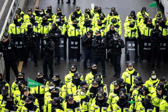 Police officers in Seoul as people gather for a rally near President Yoon Suk Yeol's residence