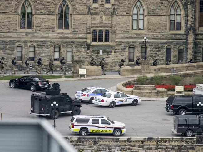 Police teams enter Centre Block at Parliament Hill in Ottawa.